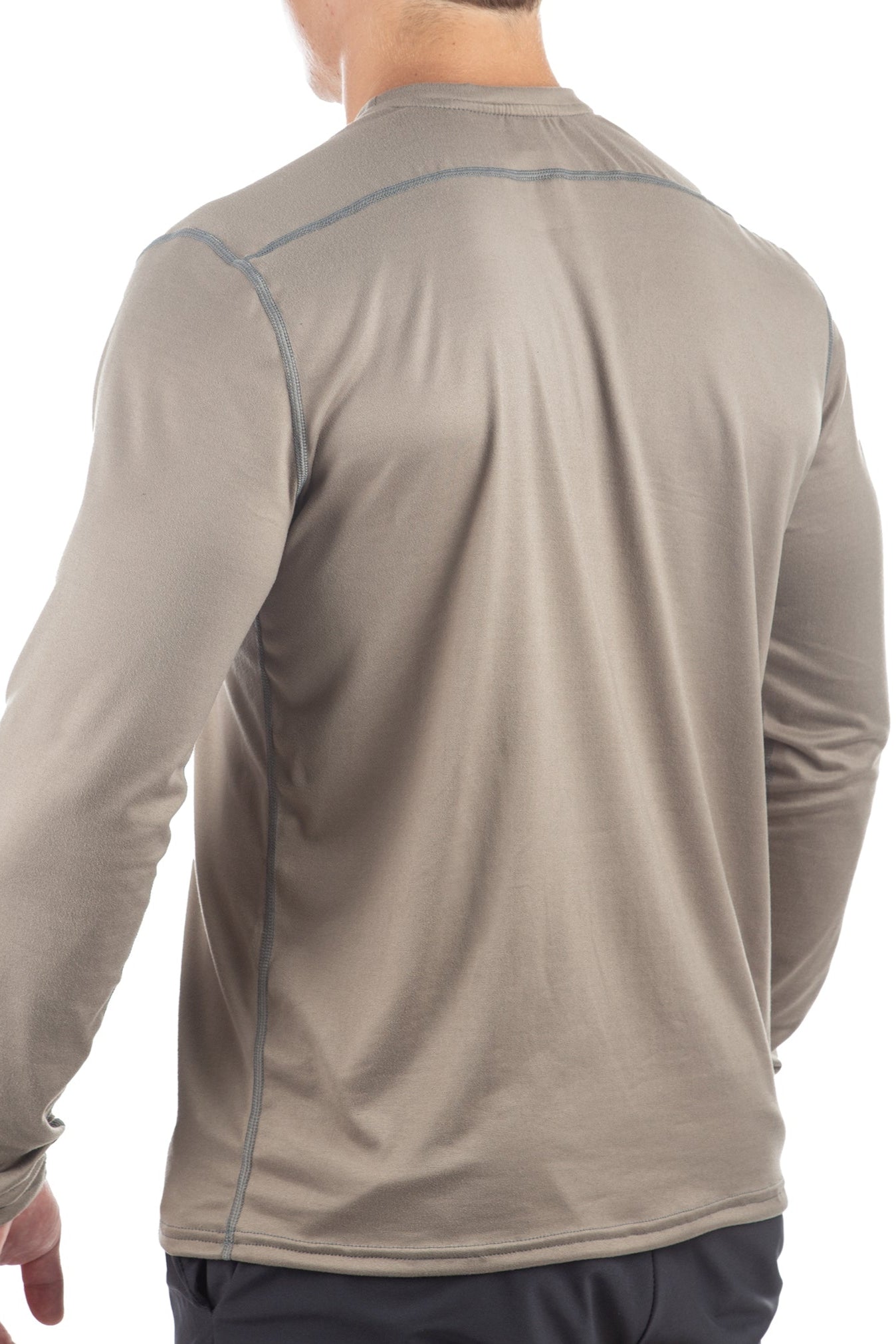 Beige long-sleeve shirt worn by a person on a white background