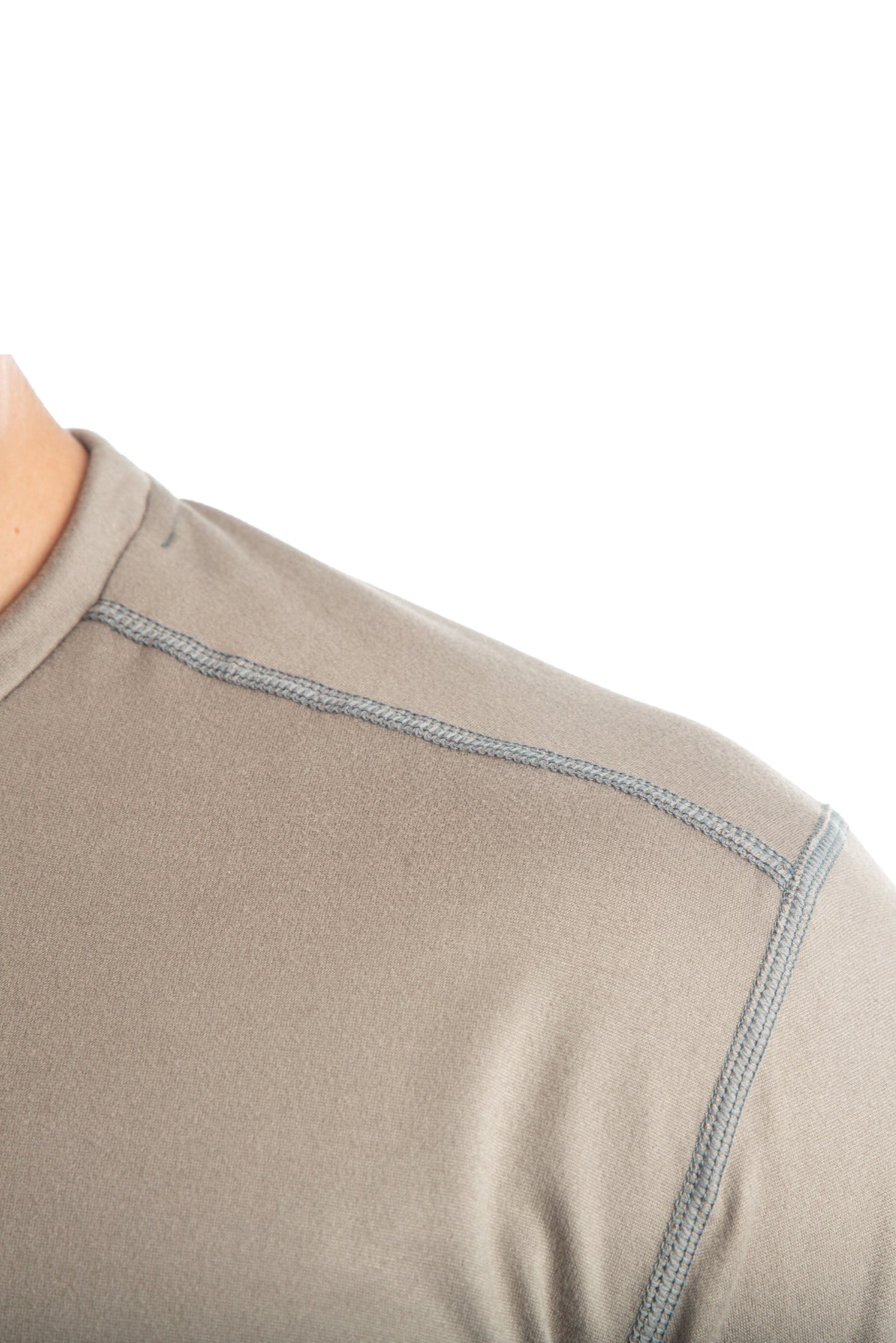 Close-up of a beige long-sleeve shirt with a white background