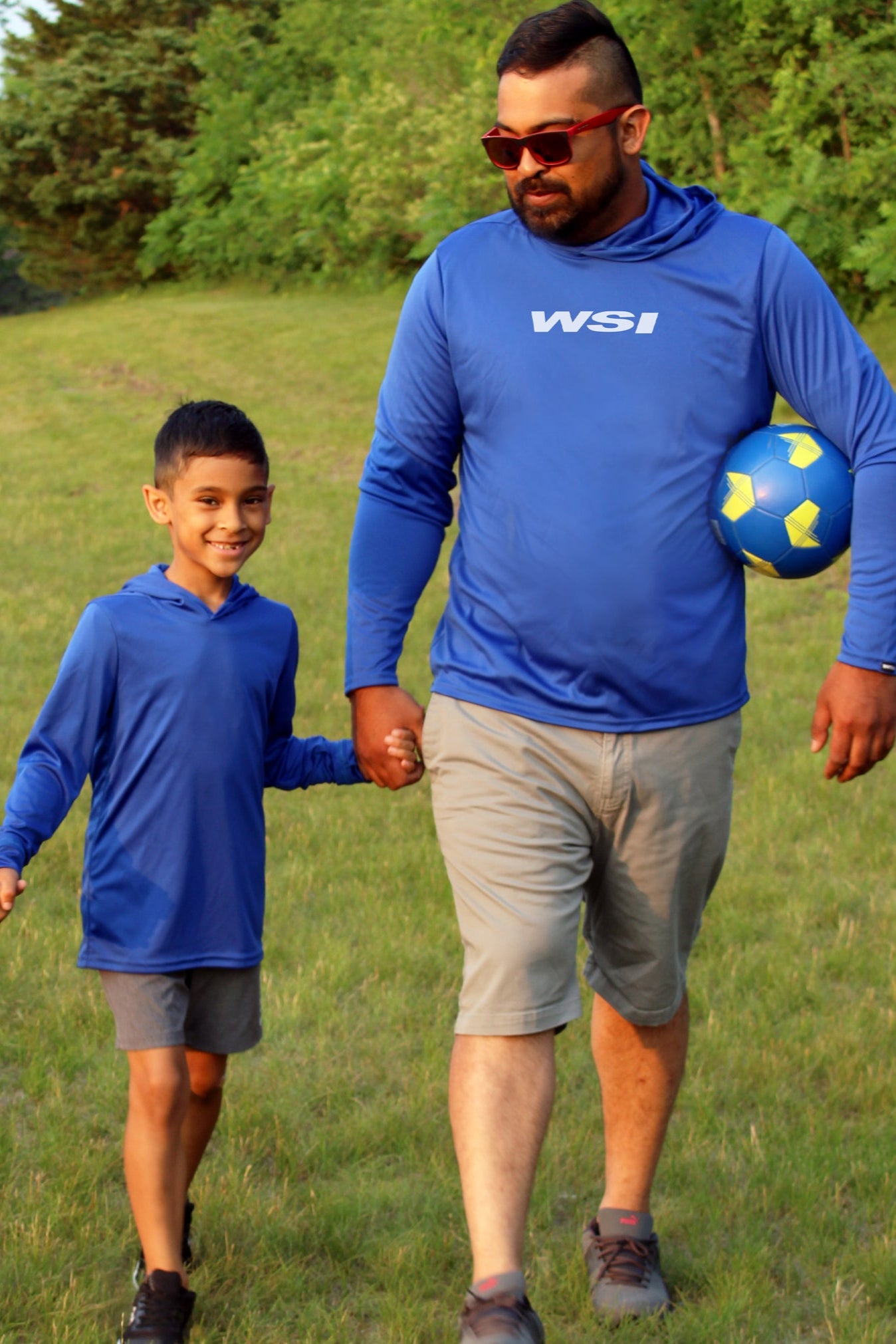 A father and son wearing matching Blue Hoodies