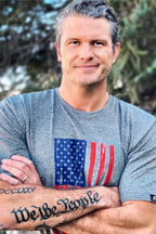 Man with folded arms wearing a Light Grey T-shirt with a USA Flag and Eagle Print